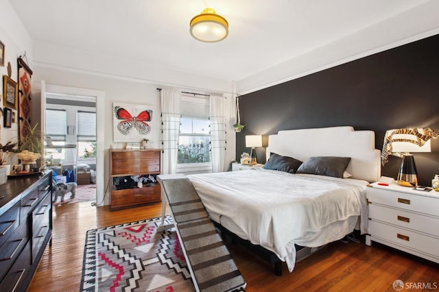 bedroom featuring dark wood-type flooring and multiple windows