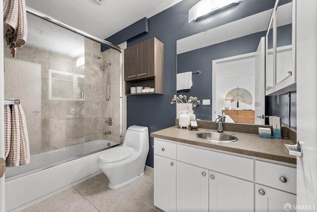 full bathroom featuring tile patterned flooring, shower / bath combination with glass door, vanity, and toilet