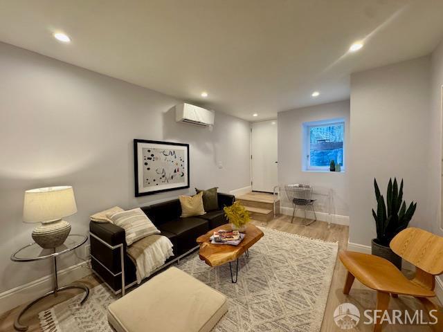 672 Prentiss St, San Francisco, CA 94110 - living area featuring an AC wall unit, baseboards, recessed lighting, and wood finished floors