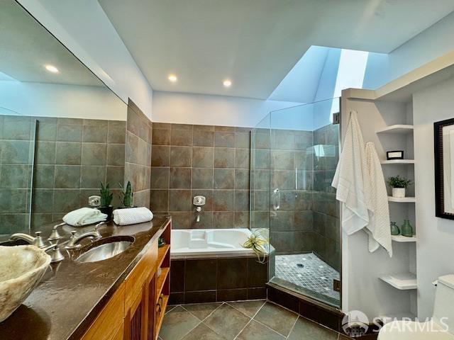 672 Prentiss St, San Francisco, CA 94110 - full bathroom featuring tile patterned floors, a garden tub, vanity, tiled shower, and tile walls
