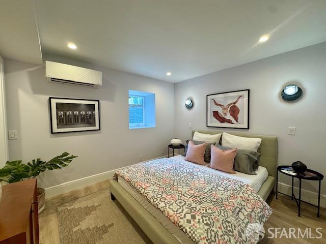 672 Prentiss St, San Francisco, CA 94110 - bedroom with a wall mounted air conditioner, baseboards, recessed lighting, and wood finished floors