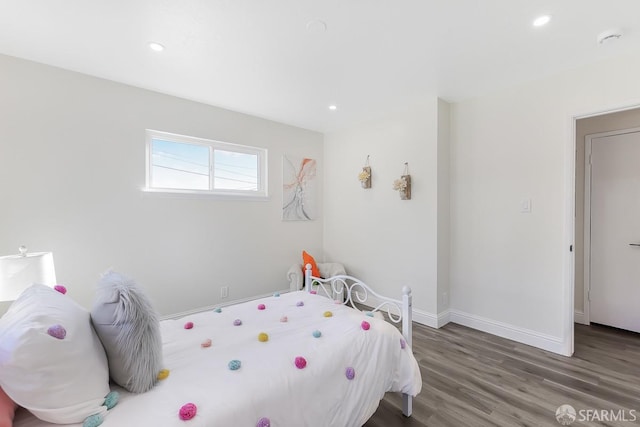 bedroom with dark hardwood / wood-style flooring