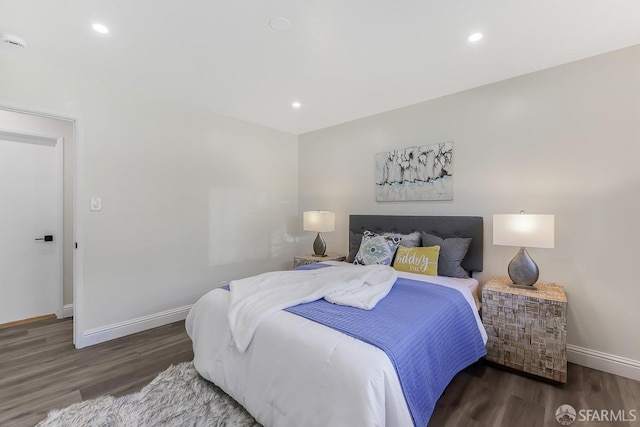 bedroom with dark wood-type flooring