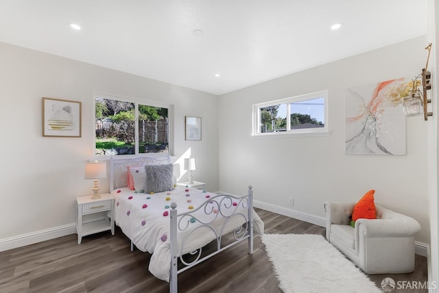 bedroom featuring dark hardwood / wood-style flooring and multiple windows