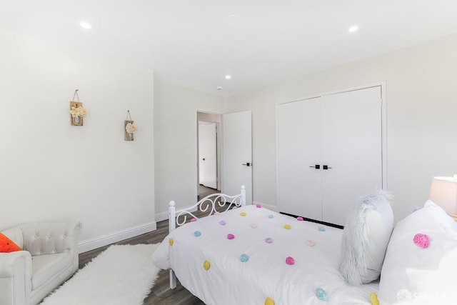 bedroom with dark hardwood / wood-style floors