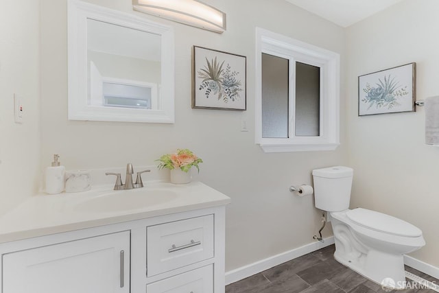 bathroom featuring hardwood / wood-style flooring, vanity, and toilet