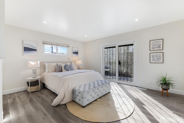 bedroom featuring access to exterior and hardwood / wood-style floors