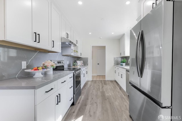 kitchen with white cabinets, backsplash, and stainless steel appliances