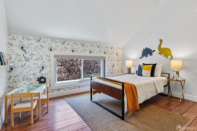 bedroom featuring wallpapered walls, lofted ceiling, baseboards, and hardwood / wood-style floors