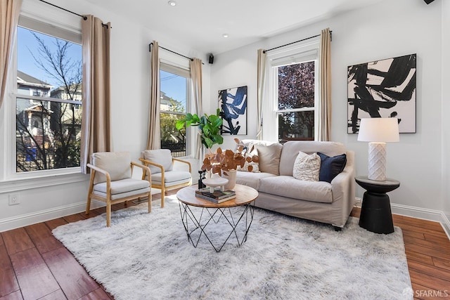 living room featuring recessed lighting, baseboards, and wood-type flooring