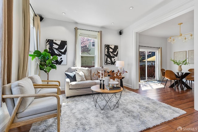 living room with recessed lighting, baseboards, a chandelier, and hardwood / wood-style flooring