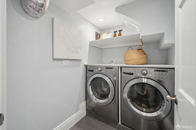 washroom with separate washer and dryer and dark tile patterned flooring