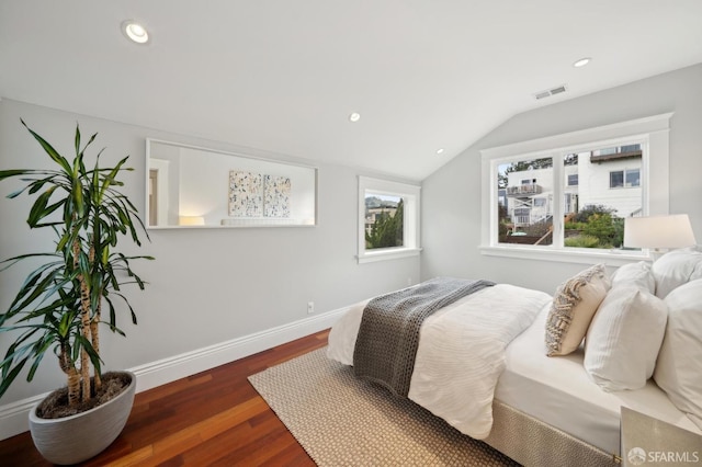 bedroom with lofted ceiling and dark wood-type flooring