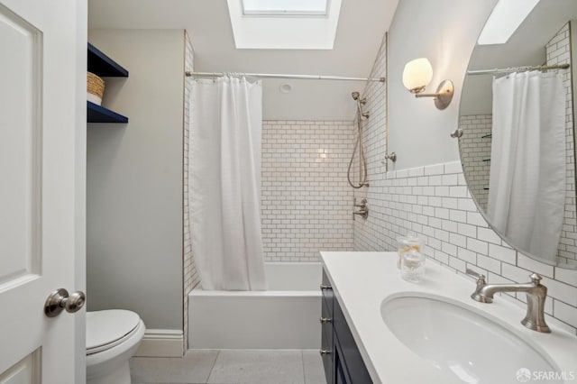 full bathroom featuring toilet, tile walls, vanity, shower / bath combo with shower curtain, and tile patterned flooring