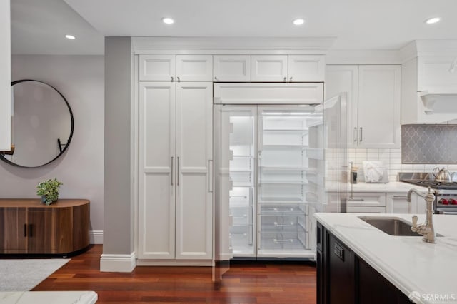 kitchen with stainless steel fridge, sink, white cabinets, and dark hardwood / wood-style floors