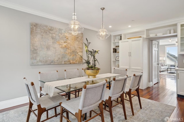 dining space featuring ornamental molding and dark hardwood / wood-style floors