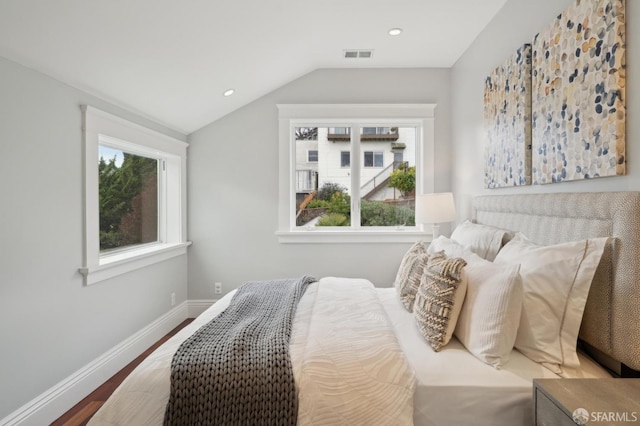 bedroom with vaulted ceiling and wood-type flooring