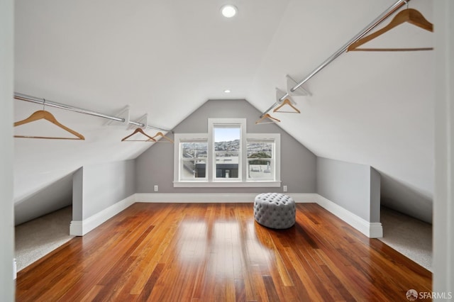 bonus room featuring vaulted ceiling and hardwood / wood-style floors