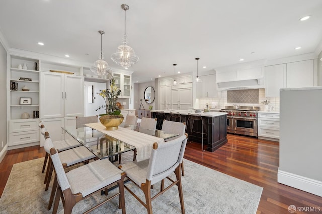 dining space featuring dark hardwood / wood-style floors and a chandelier