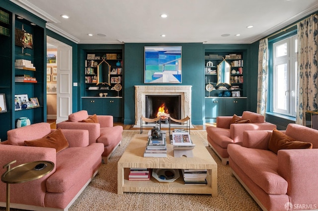 interior space featuring recessed lighting, built in shelves, ornamental molding, and a high end fireplace