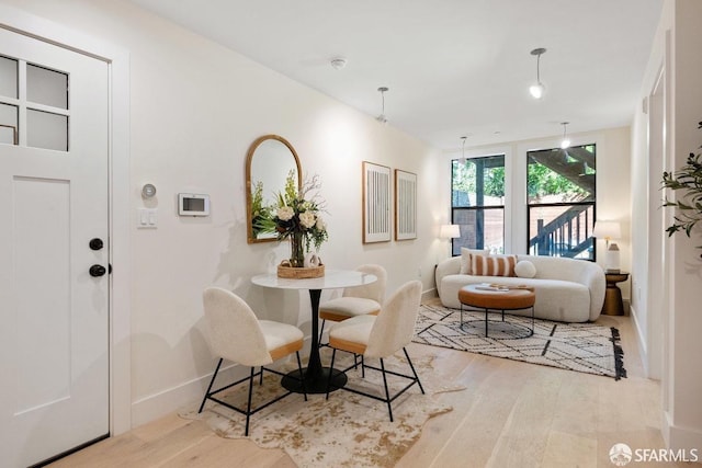 dining space with light hardwood / wood-style flooring