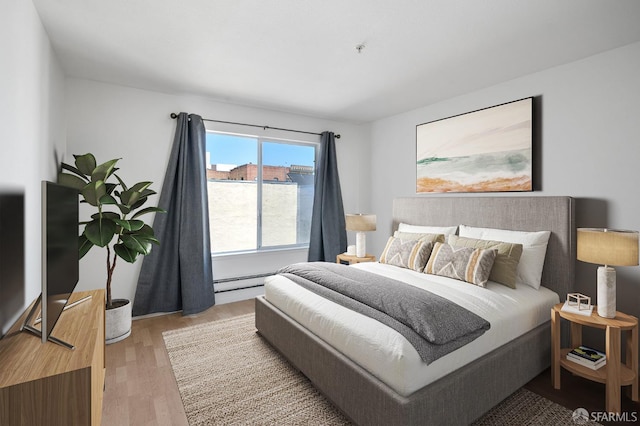 550 S Van Ness Ave Unit 306, San Francisco, CA 94110 - bedroom with light wood-type flooring and a baseboard radiator