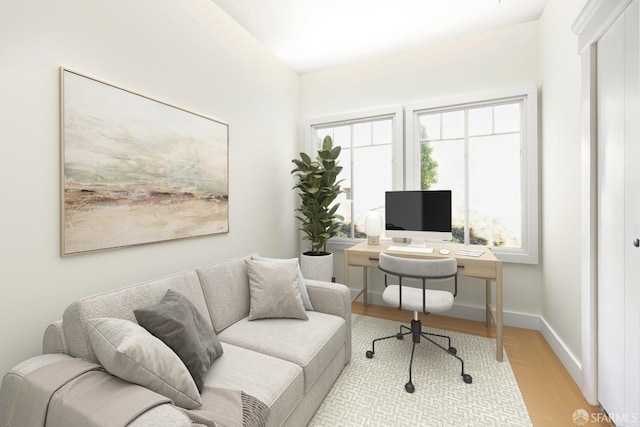 home office with light hardwood / wood-style floors