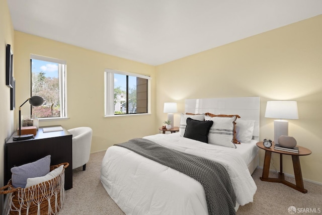 carpeted bedroom featuring baseboards