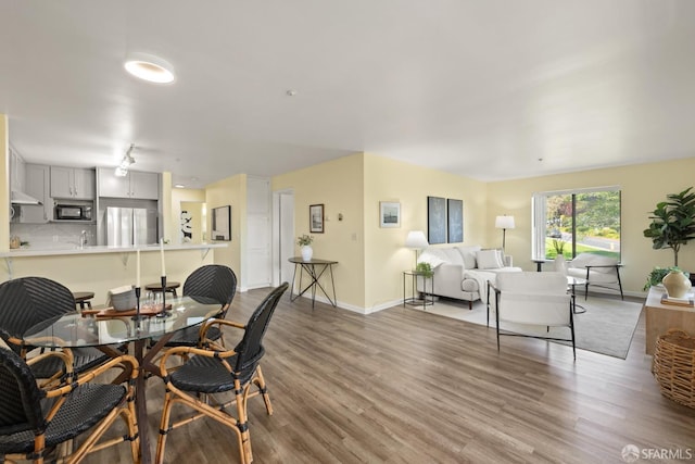 dining room with wood finished floors and baseboards