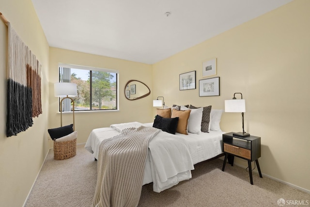 bedroom with baseboards and carpet flooring