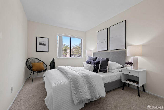 carpeted bedroom featuring baseboards