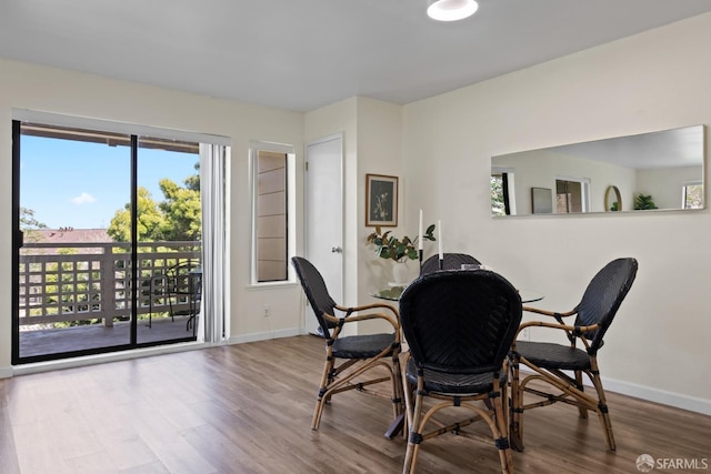 dining area featuring wood finished floors and baseboards