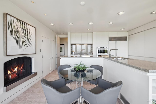 83 Mount Tiburon Rd, Tiburon, CA 94920 - dining room with a lit fireplace, light tile patterned flooring, and recessed lighting