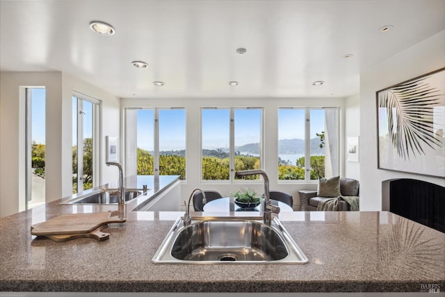 83 Mount Tiburon Rd, Tiburon, CA 94920 - kitchen with a mountain view, recessed lighting, open floor plan, dark stone counters, and an island with sink