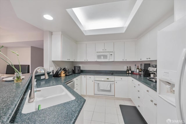 130 E San Fernando St Unit 513, San Jose, CA 95112 - kitchen with white appliances, white cabinets, dark countertops, a sink, and light tile patterned flooring