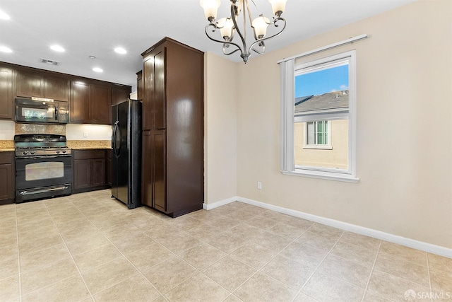 kitchen featuring dark brown cabinetry, baseboards, visible vents, light stone counters, and black appliances