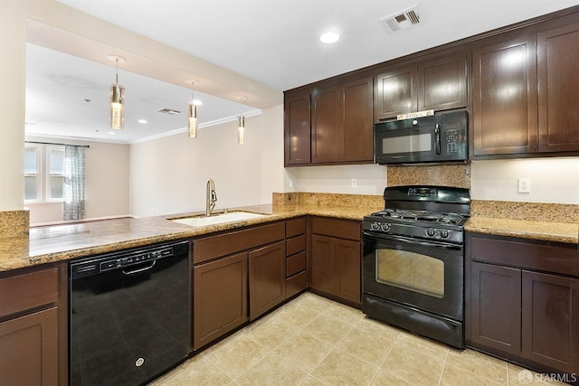 kitchen featuring dark brown cabinetry, a sink, visible vents, black appliances, and decorative light fixtures