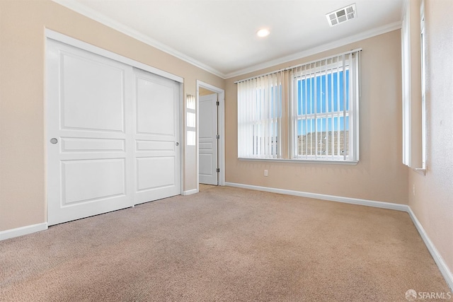 unfurnished bedroom with ornamental molding, visible vents, and baseboards