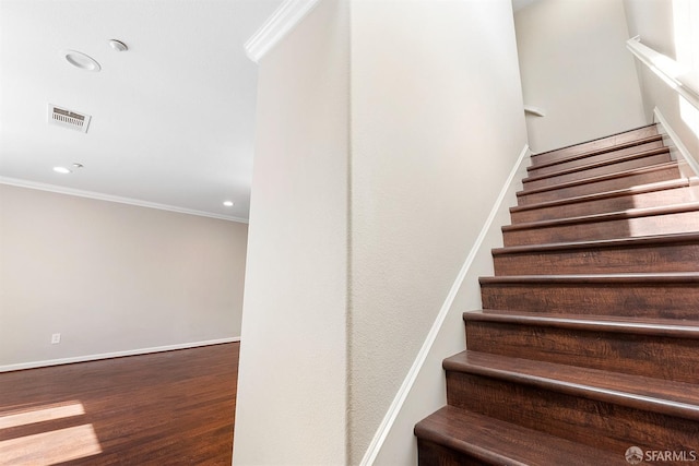 staircase with recessed lighting, visible vents, ornamental molding, wood finished floors, and baseboards