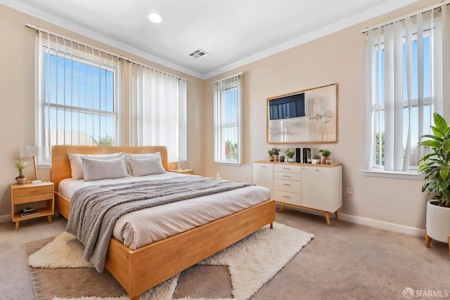 bedroom with light carpet, visible vents, baseboards, ornamental molding, and multiple windows