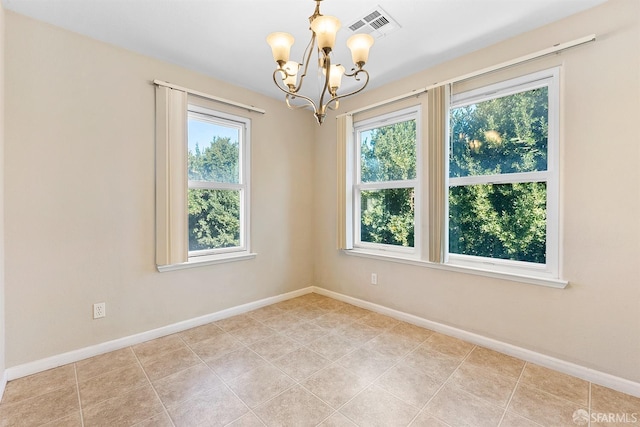 empty room featuring an inviting chandelier, baseboards, visible vents, and tile patterned flooring