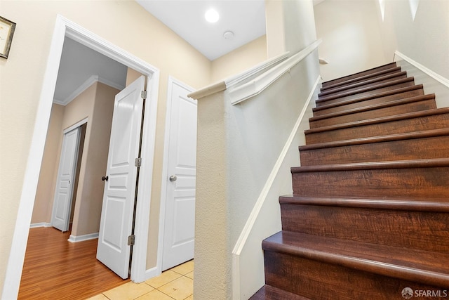 stairs with tile patterned flooring and baseboards