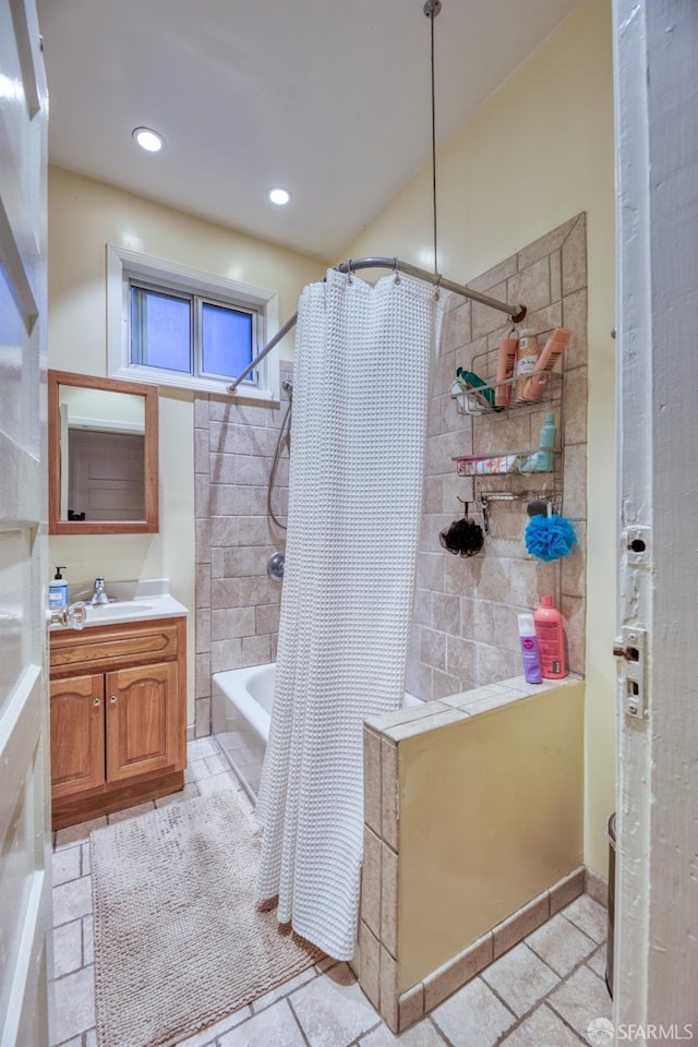 bathroom featuring shower / tub combo and vanity