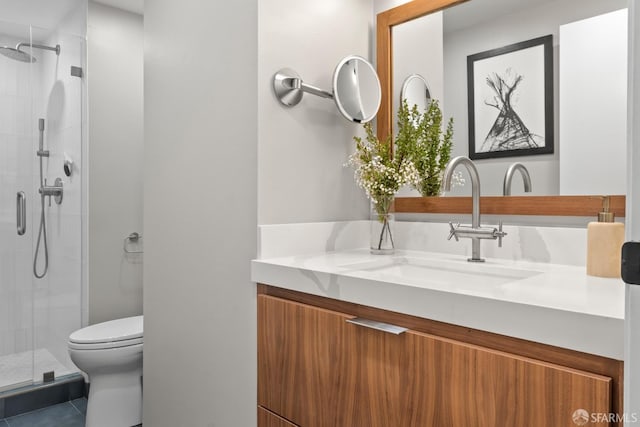 bathroom with vanity, tile patterned flooring, toilet, and a shower with door