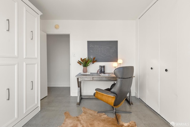 office space with finished concrete flooring and baseboards
