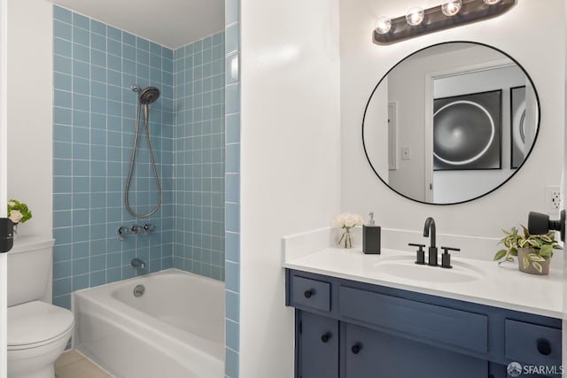 full bathroom featuring tile patterned flooring, vanity, toilet, and tiled shower / bath