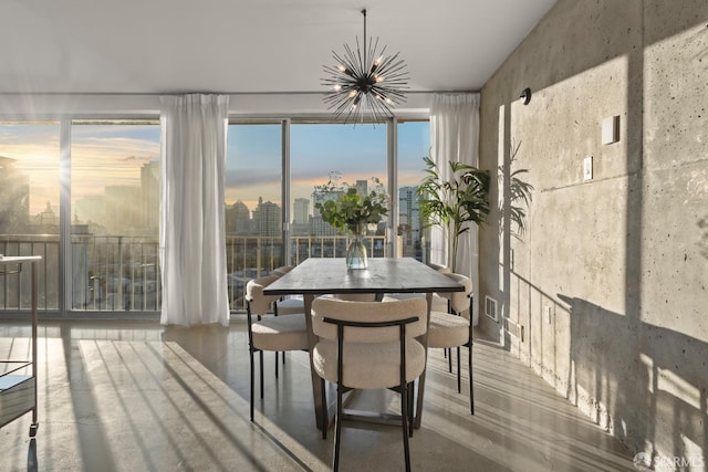 sunroom / solarium featuring a chandelier