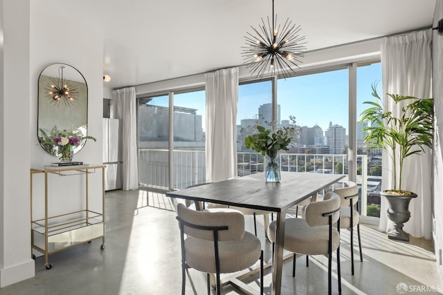 dining area with a chandelier, a view of skyline, and concrete floors