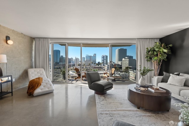 living room featuring a skyline view and finished concrete floors