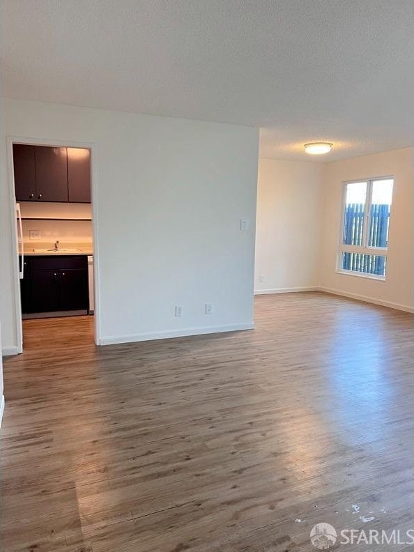 spare room with light hardwood / wood-style flooring